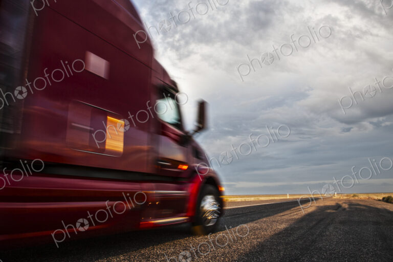Side view of the cab of a commercial truck on the highway in eastern Washington, USA.
