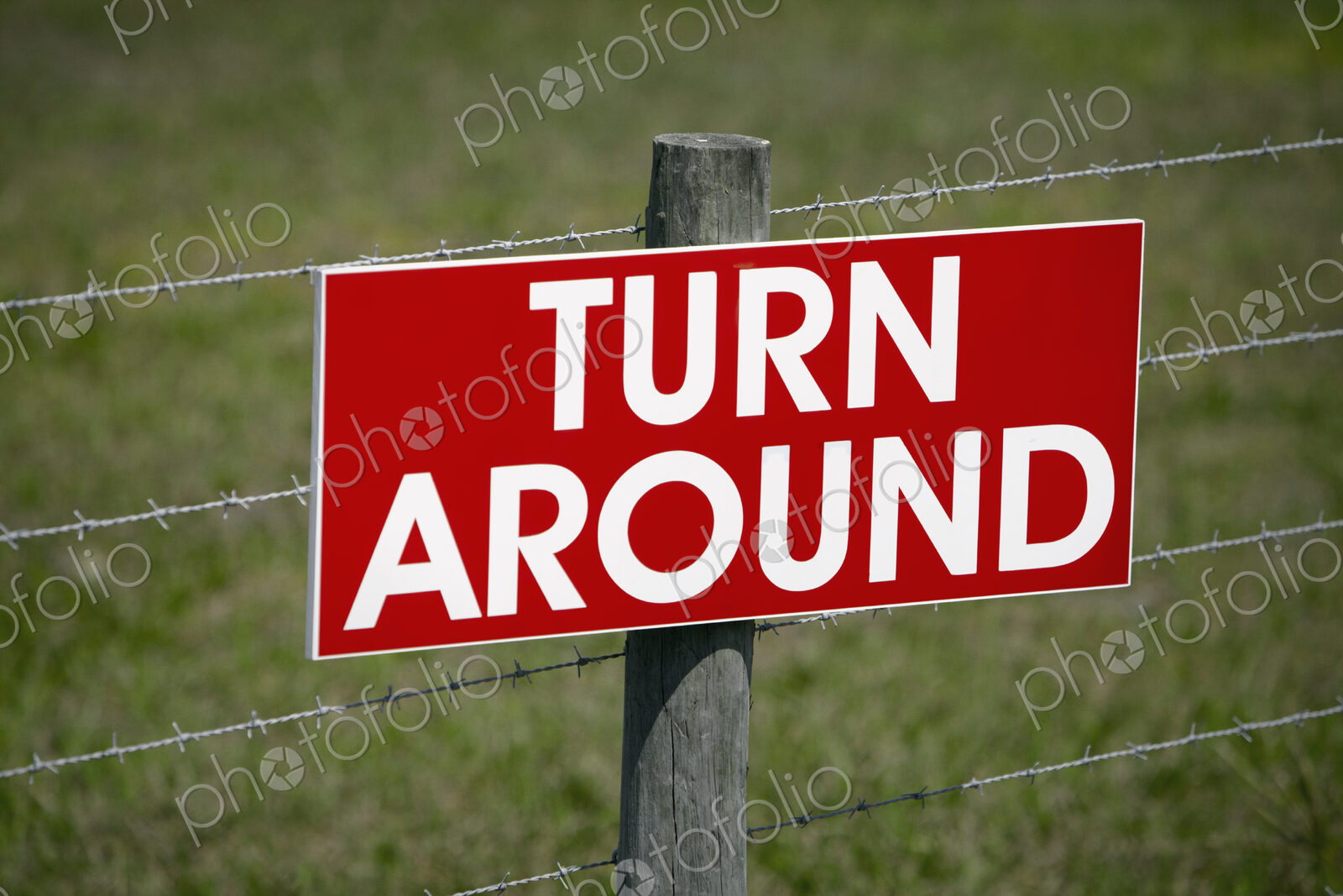 Sign on a Barbwire Fence