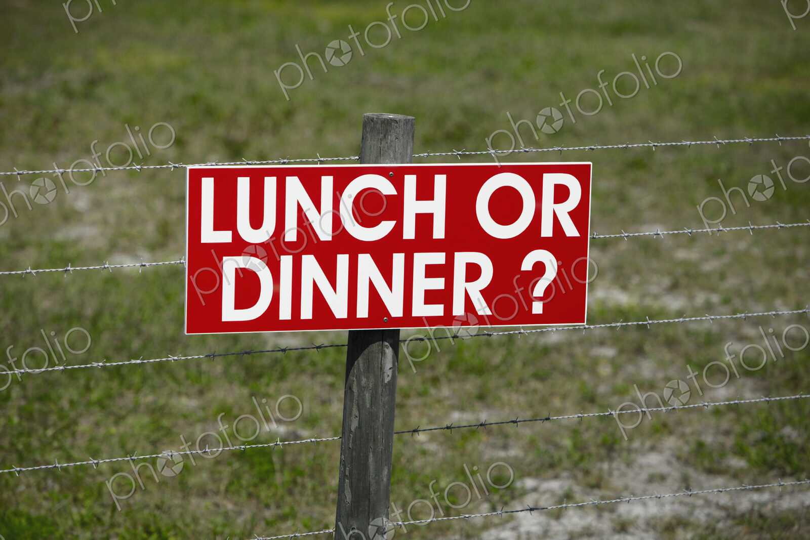 Sign on a Barbwire Fence