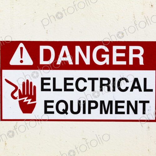 Signs on a ferry warning of electrical equipment. Danger symbol.