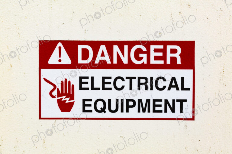 Signs on a ferry warning of electrical equipment. Danger symbol.