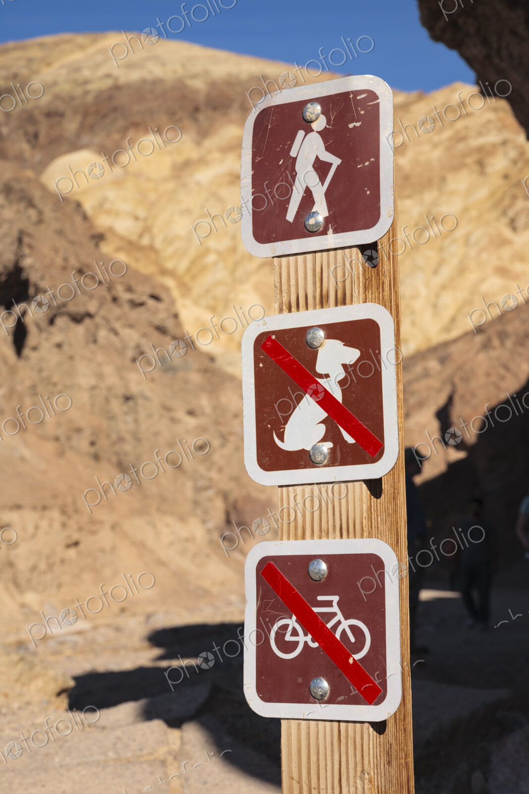 Signs on a walking trail in a national park. No Dogs and No Bicycles.