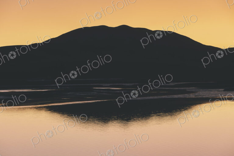 Silhouette of Black Mountain at dawn, Tamales Bay in foreground, Point Reyes National…