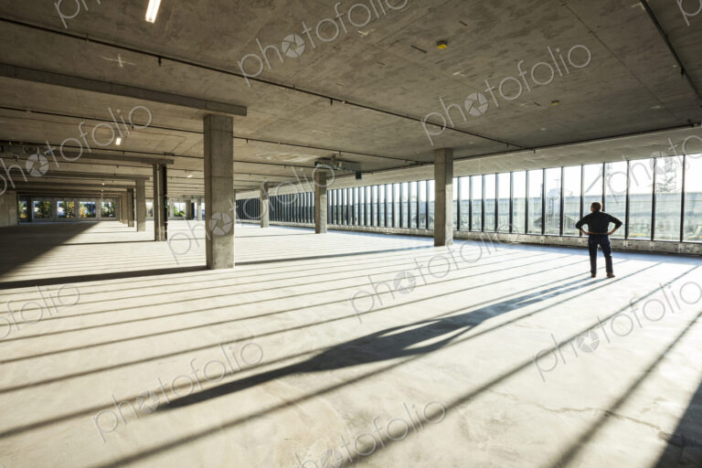 Single businessman in new empty raw business space for a new office