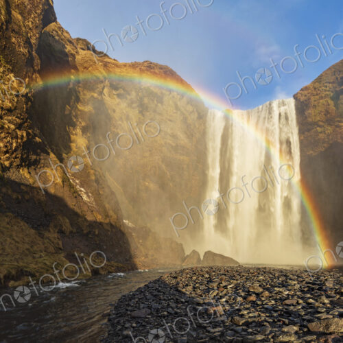 Skagafoss waterfall, cliffs and a Double Rainbow, a cascade falling into a pool. Skagafoss waterfall, cliffs and a Double Rainbow, a cascade falling into a pool.