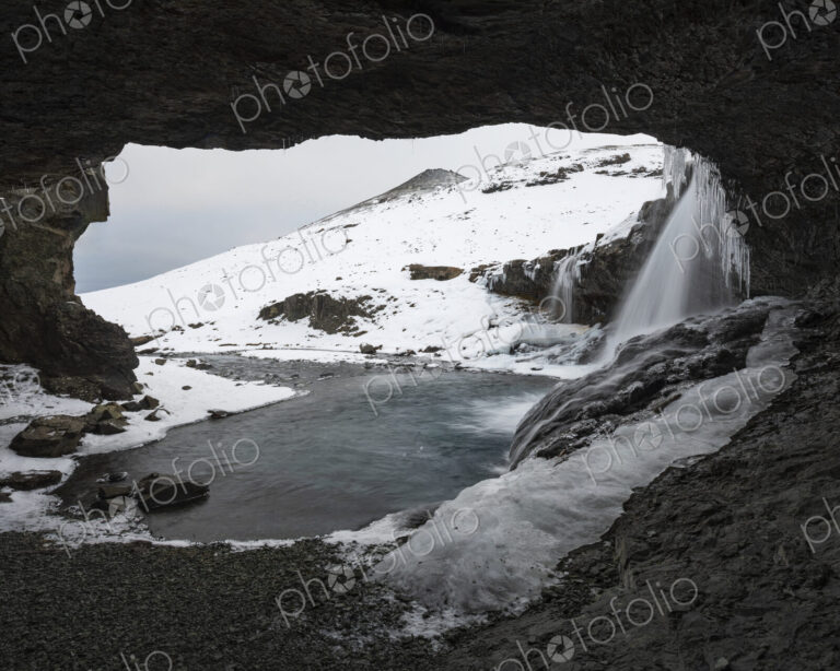 Skógafoss waterfall on the Skoga river, a cascade flowing into the river, view from a…