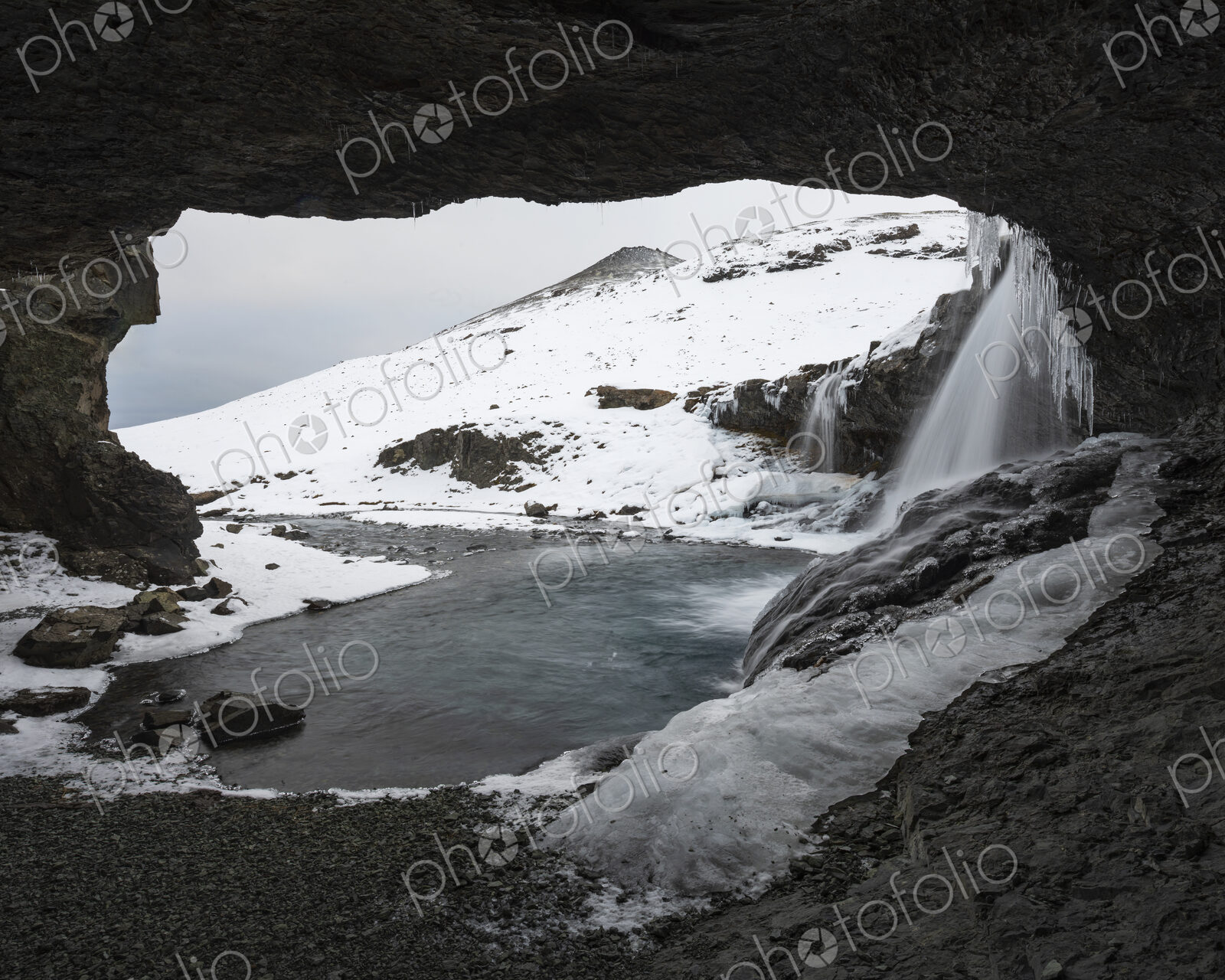 Skógafoss waterfall on the Skoga river, a cascade flowing into the river, view from a…