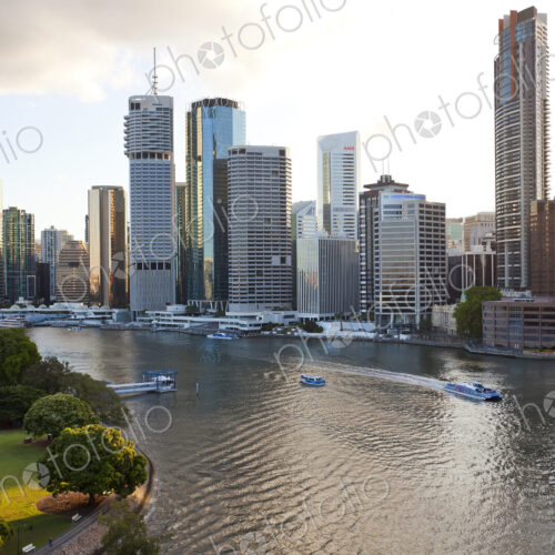Skyline of city by the ocean, with skyscrapers and boats on the river. Skyline of city by the ocean, with skyscrapers and boats on the river.