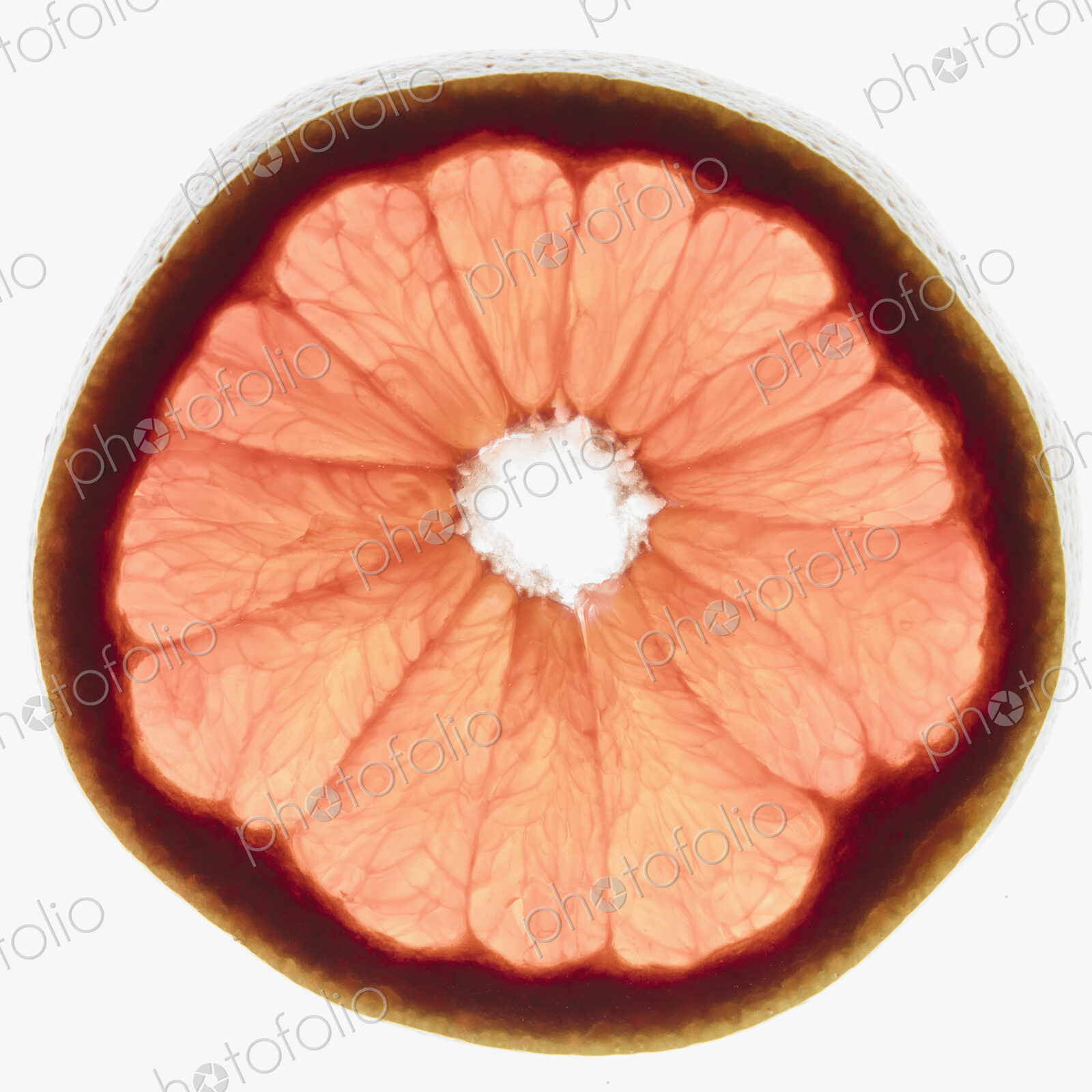 Slice of organic ruby red grapefruit on white background