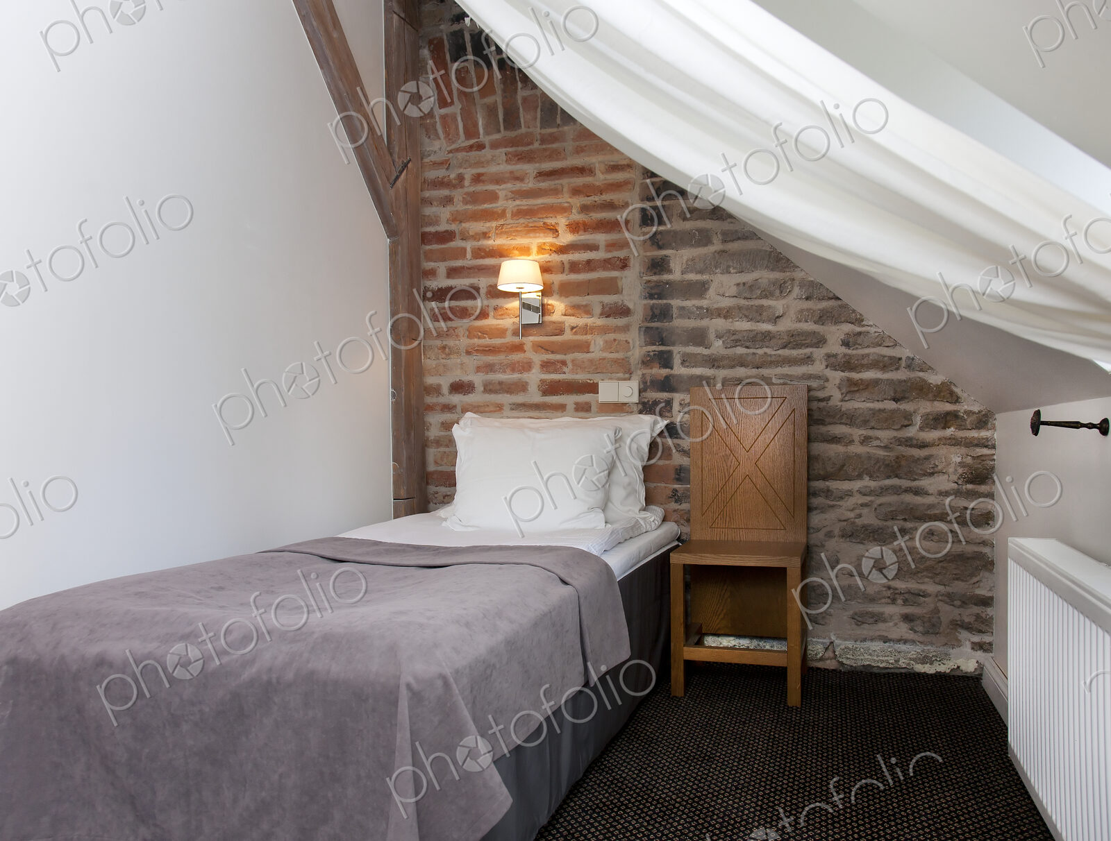 Small Bedroom With a Stone Wall