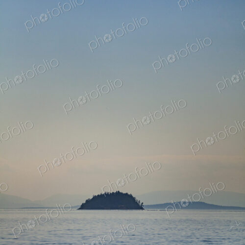 Small island viewed across the water, in the San Juan Islands Small island viewed across the water, in the San Juan Islands