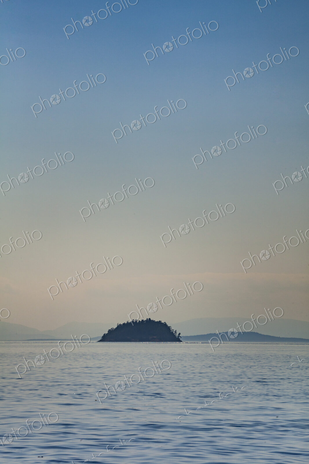 Small island viewed across the water, in the San Juan Islands