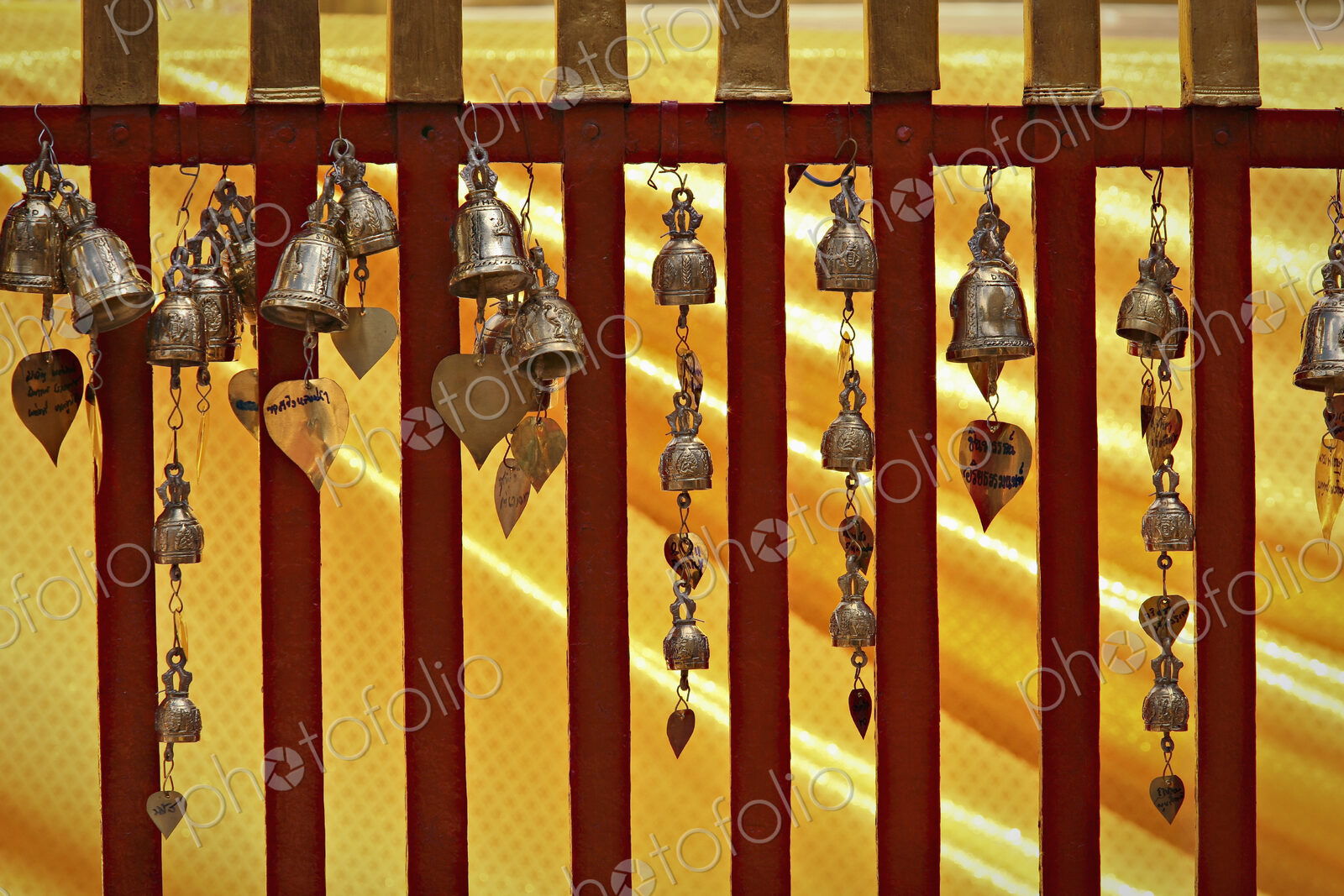 Small metal bells hanging from a railing in an ancient temple, Chang Mai