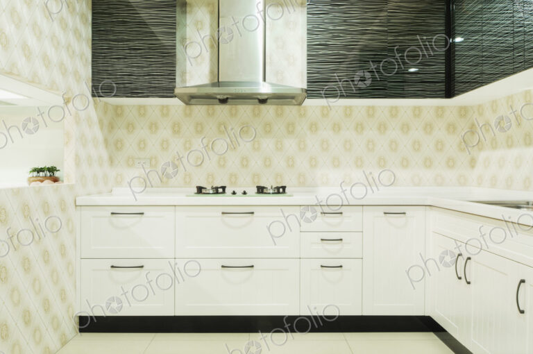 Small modern kitchen with fitted units with white doors. Black glass features, gas…