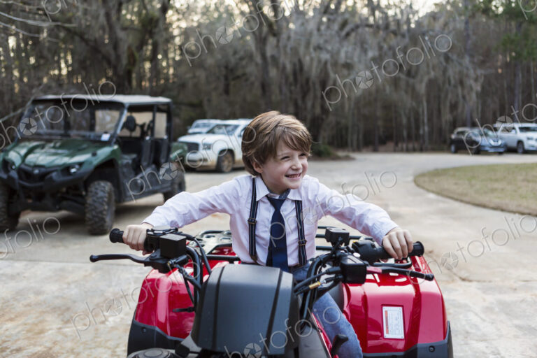 Smiling 6 year old boy on ATV, Georgia