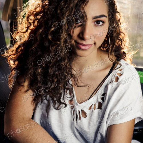 Smiling mixed race woman sitting in a car Smiling mixed race woman sitting in a car