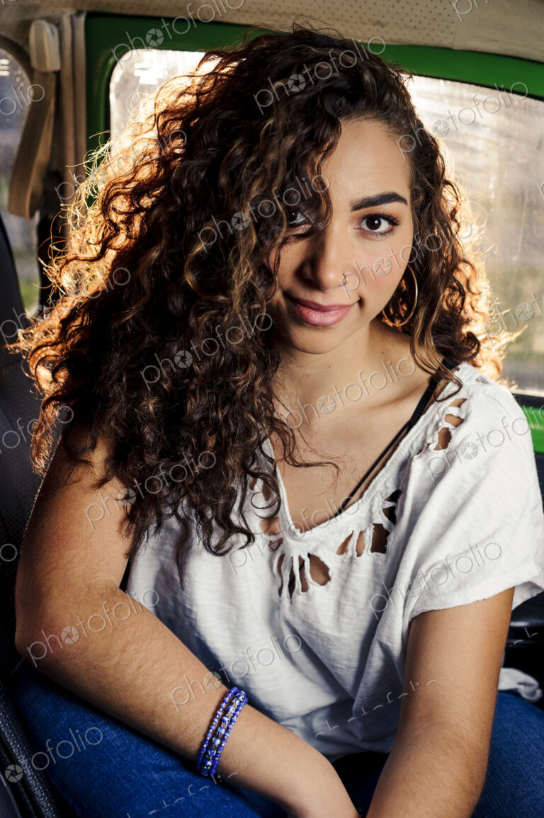 Smiling mixed race woman sitting in a car