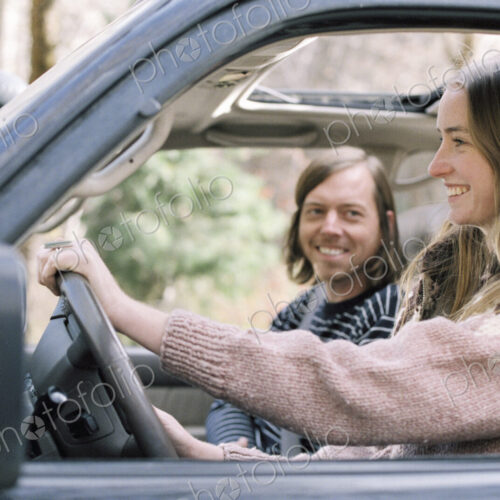 Smiling young couple driving in their car. Smiling young couple driving in their car.