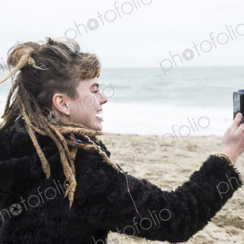Smiling young woman with brown hair and dreadlocks and a lip piercing wearing black… Smiling young woman with brown hair and dreadlocks and a lip piercing wearing black…