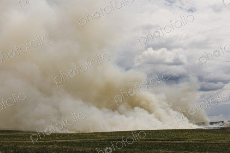 Smoke from controlled burn on farmland, seasonal burns to clear stubble.