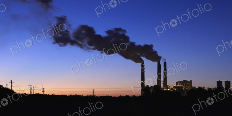 Smokestacks Billowing Smoke At Night