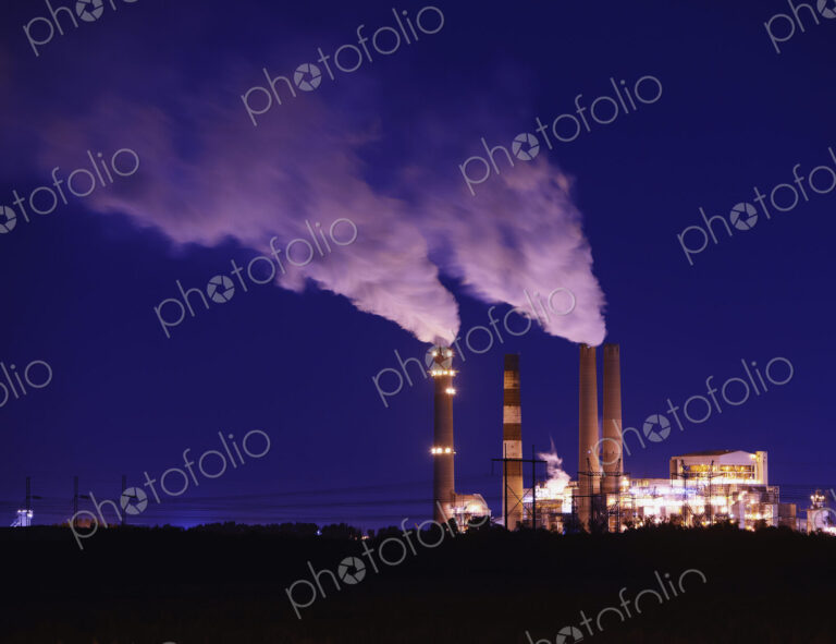 Smokestacks Billowing Smoke At Night