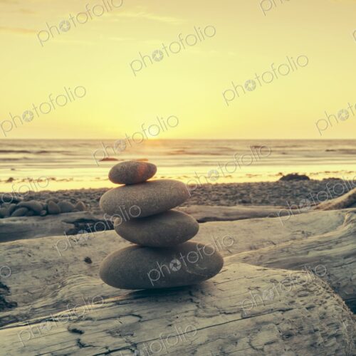 Smooth stones balanced on driftwood at Ruby Beach, Olympic Peninsula, Washington, with… Smooth stones balanced on driftwood at Ruby Beach, Olympic Peninsula, Washington, with…