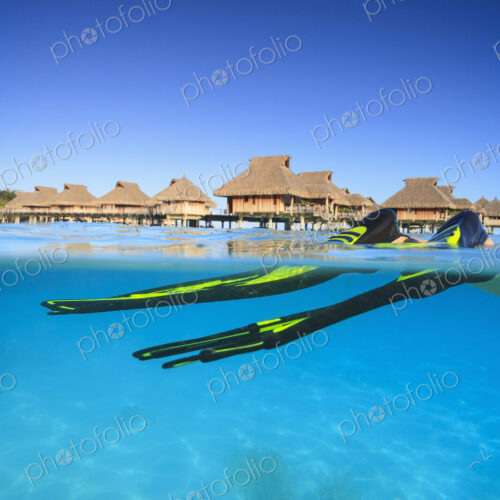 Snorkeler's flippers in tropical water, Bora Bora, French Polynesia Snorkeler's flippers in tropical water, Bora Bora, French Polynesia
