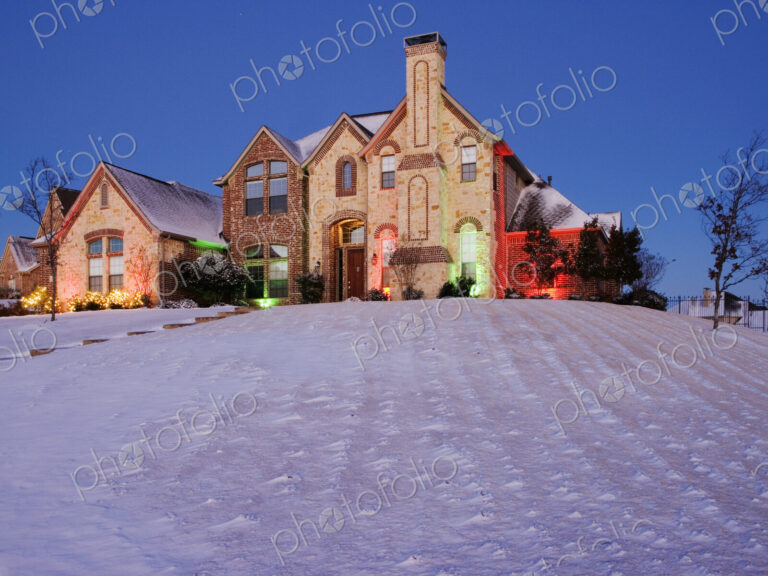 Snow Covered Yard and Stone House