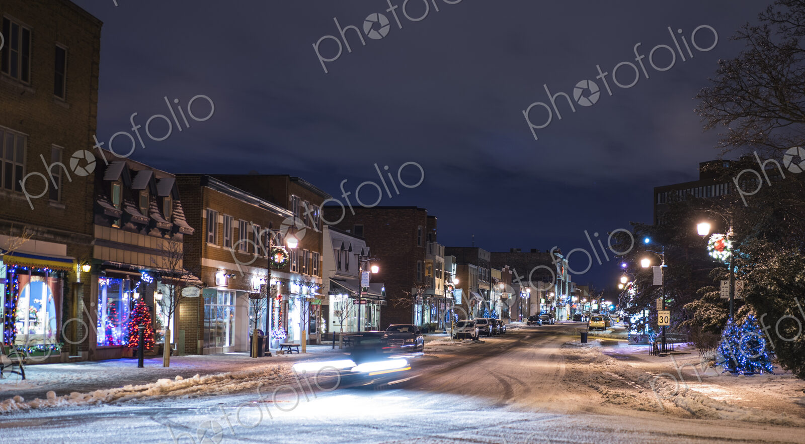 Snow on city street at night
