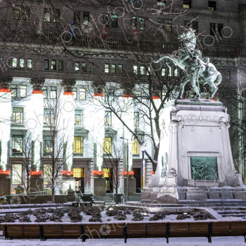 Snow on statue in city at night Snow on statue in city at night