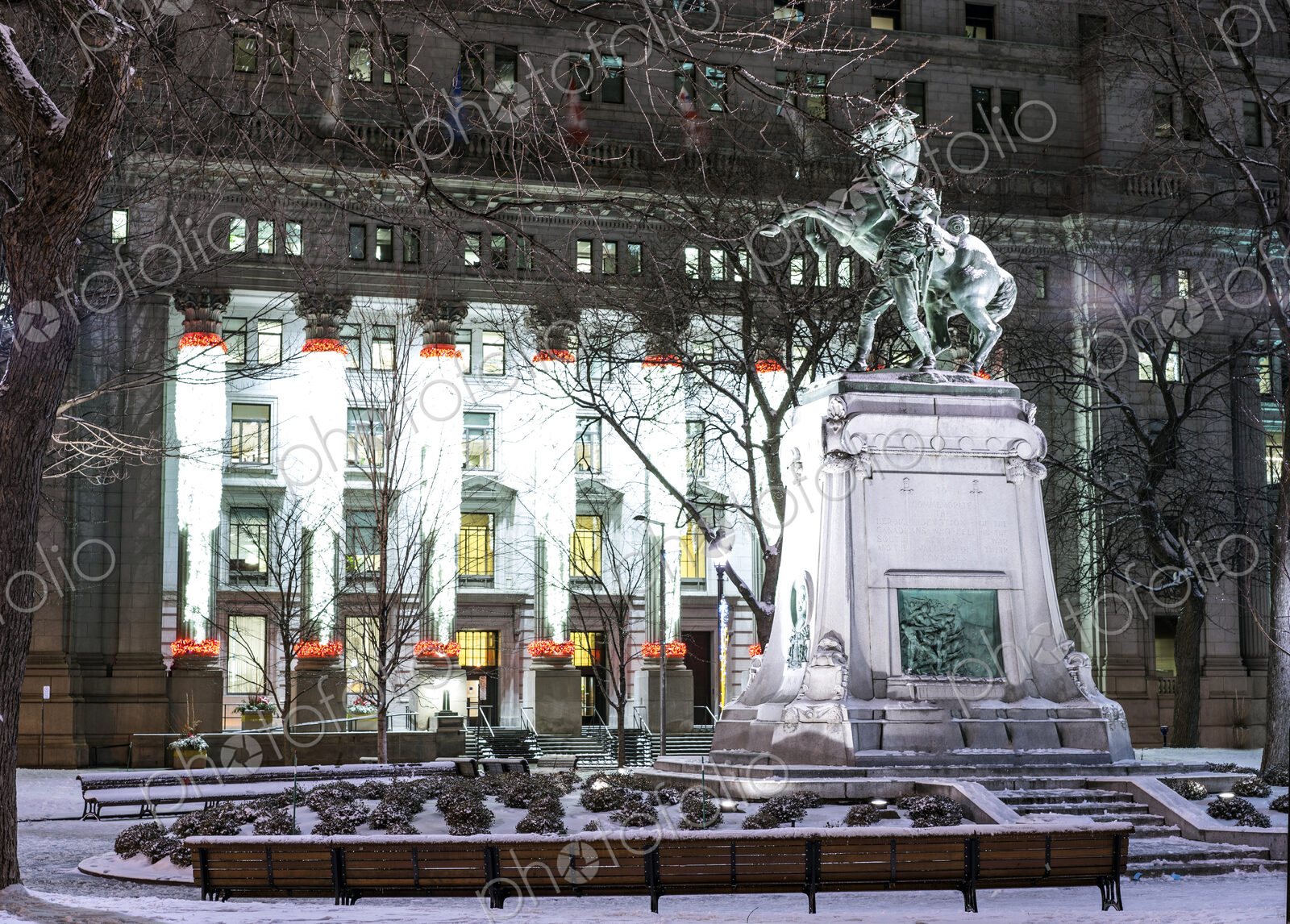 Snow on statue in city at night