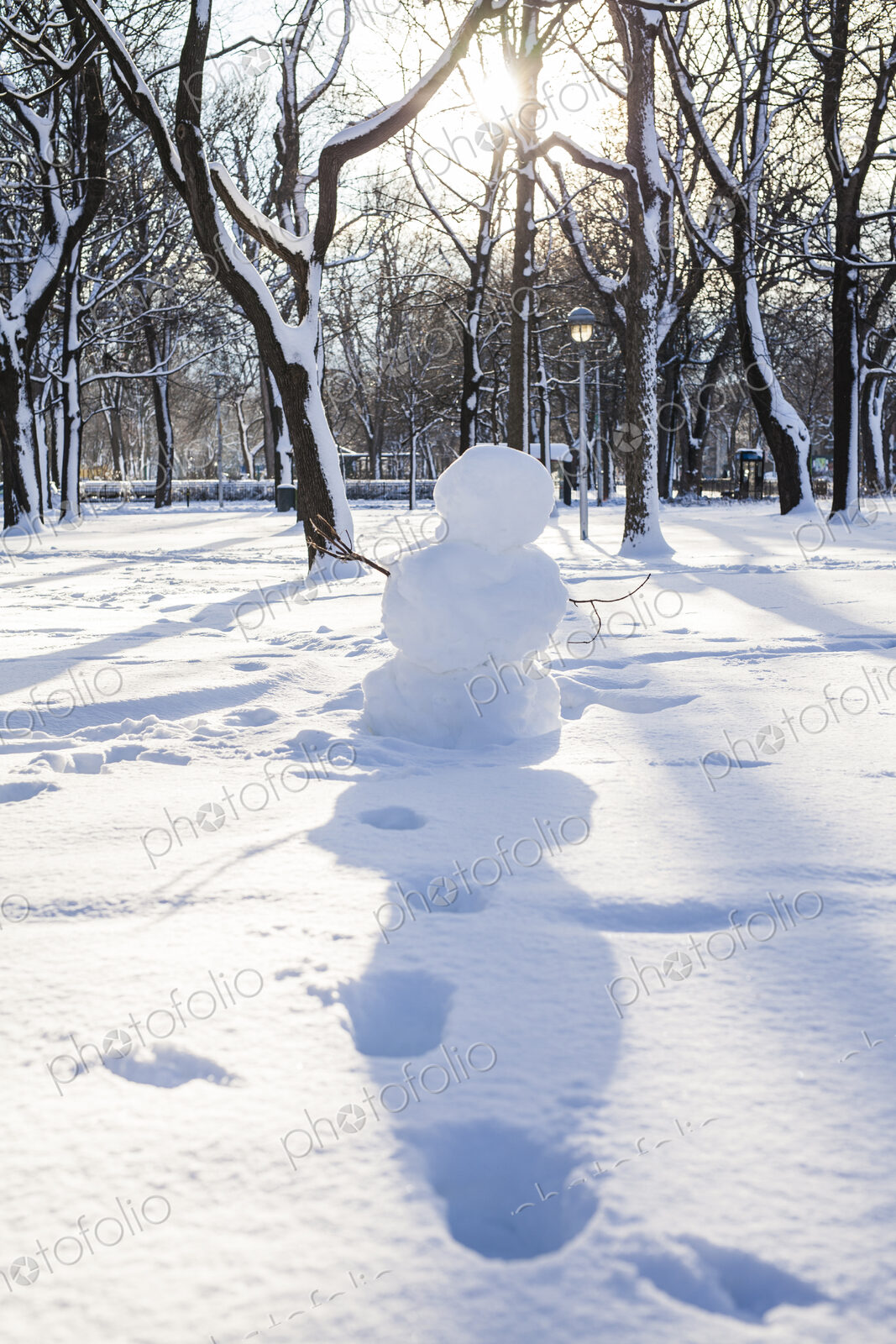 Snowman and footprints in snowy park