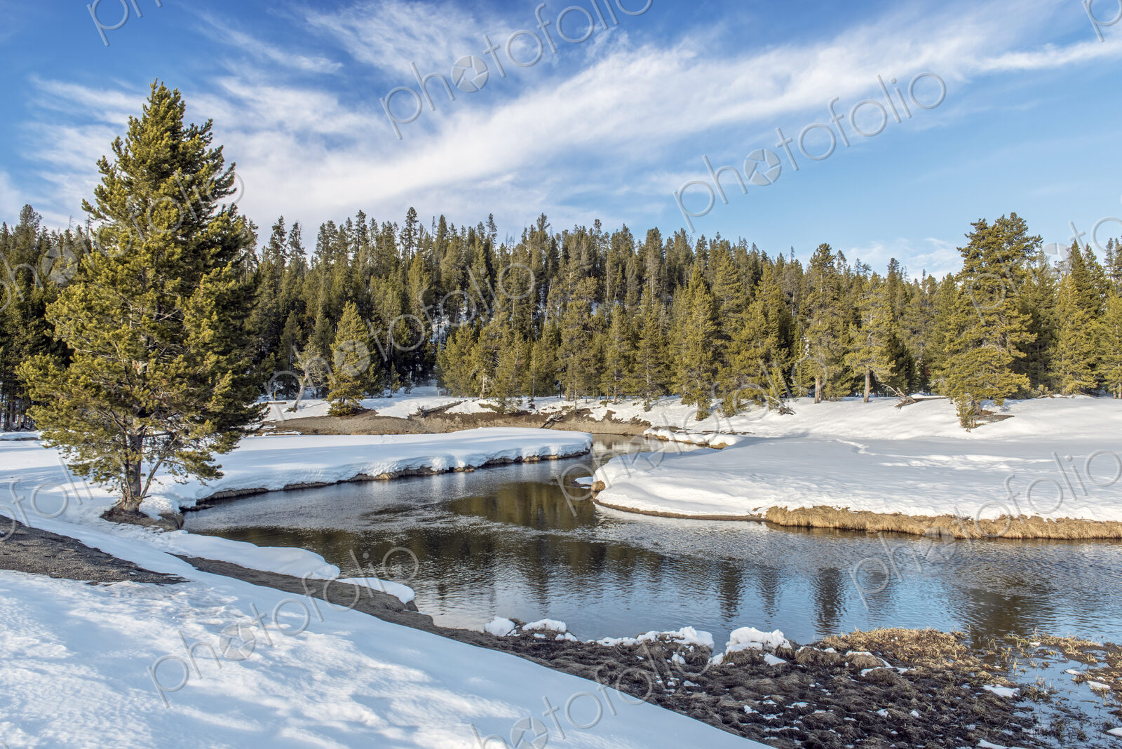 Snowy fields and hills near remote stream