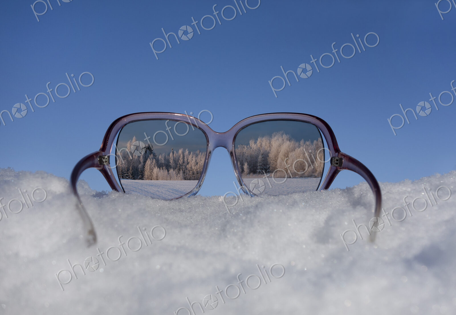 Snowy winter landscape view through sunglasses. Reflection.