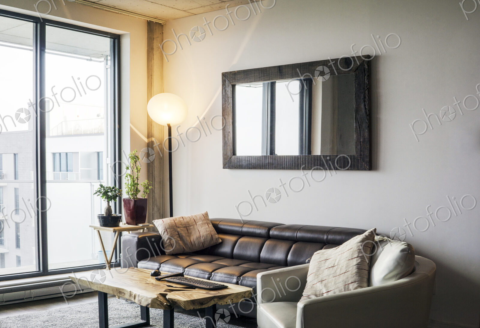 Sofa and armchair near a city living room window