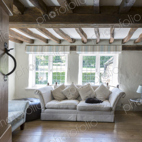 Sofa under beams in living room