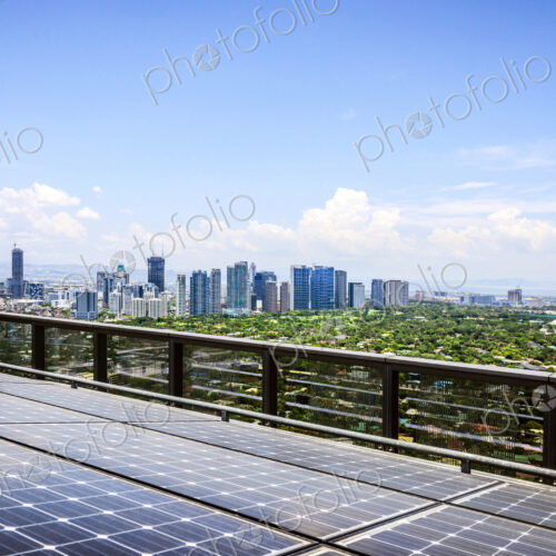 Solar panels and Manila cityscape under blue sky, Philippines Solar panels and Manila cityscape under blue sky, Philippines