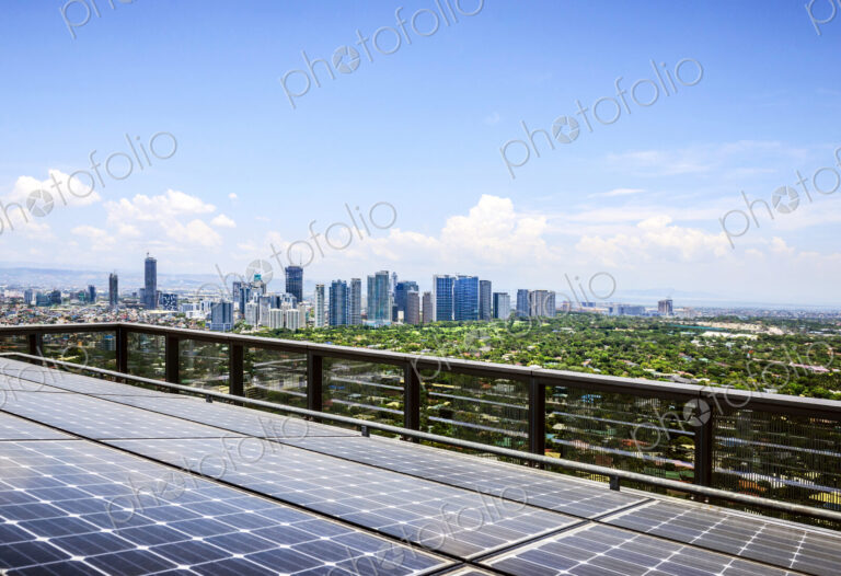 Solar panels and Manila cityscape under blue sky, Philippines