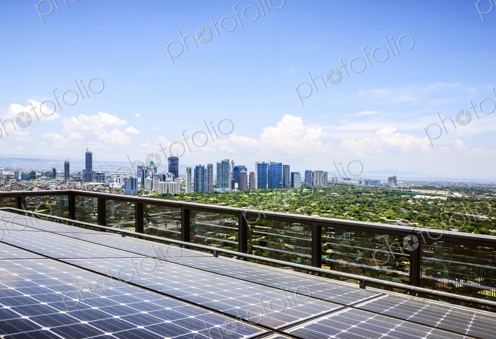 Solar panels and Manila cityscape under blue sky, Philippines
