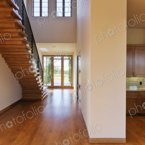Spacious Hallway Showing a Staircase and Modern Kitchen Spacious Hallway Showing a Staircase and Modern Kitchen