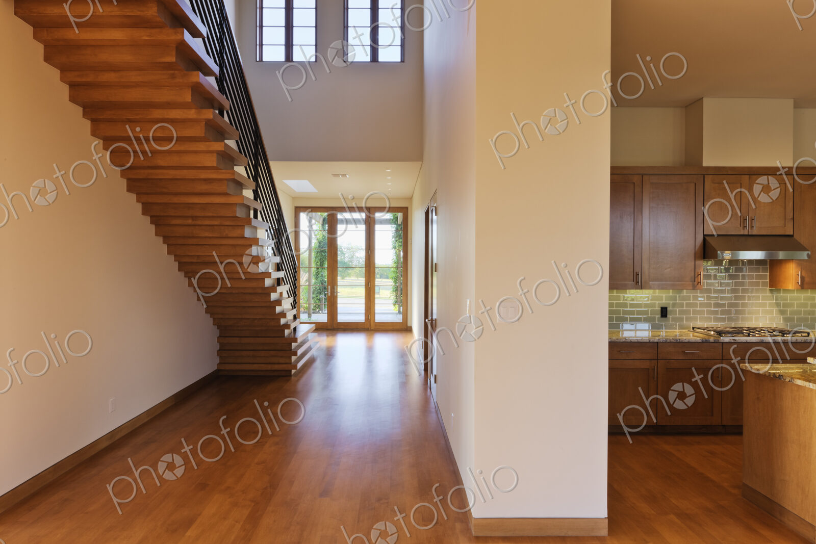 Spacious Hallway Showing a Staircase and Modern Kitchen