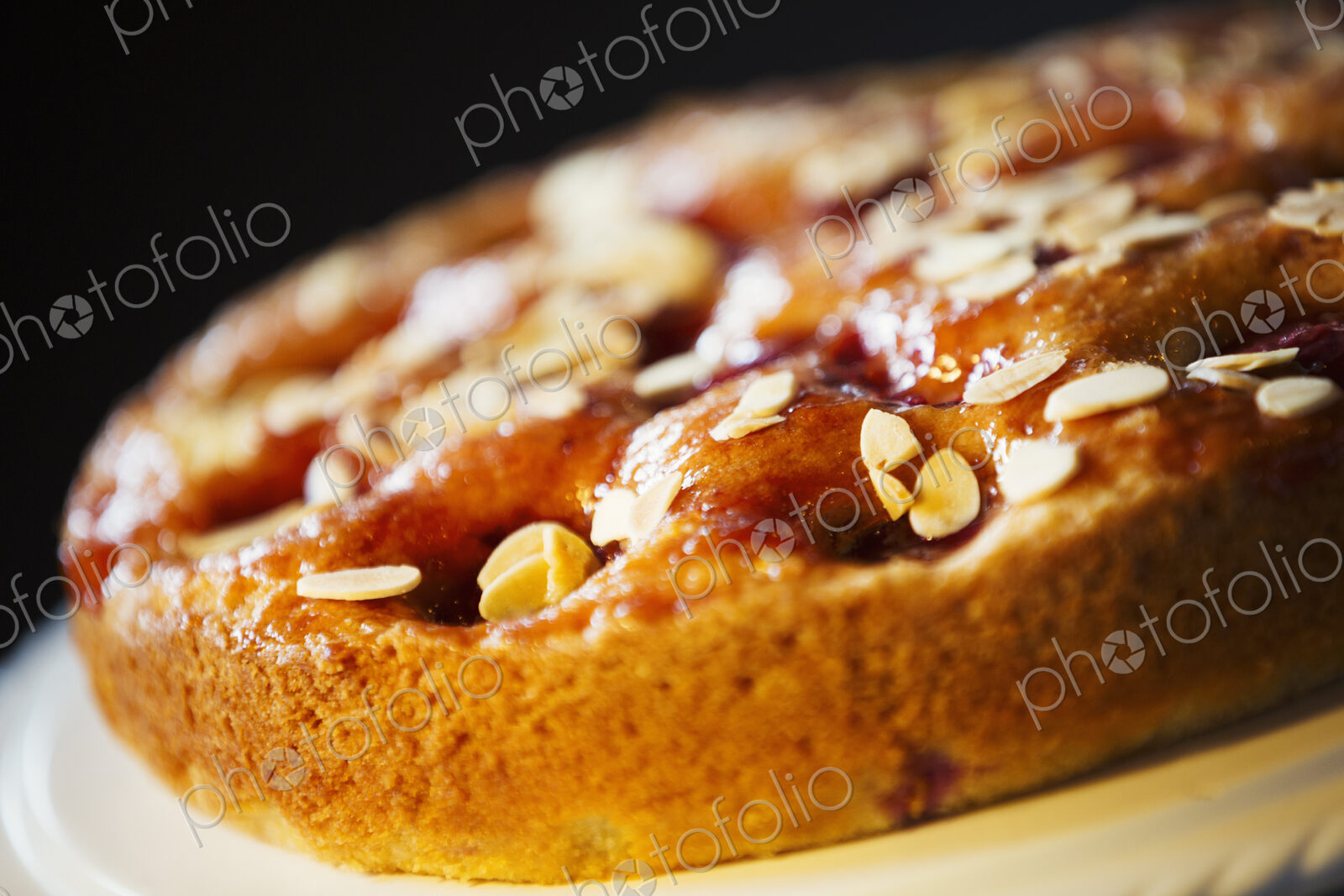 Specialist coffee shop. A fresh baked tart with almonds on the top.