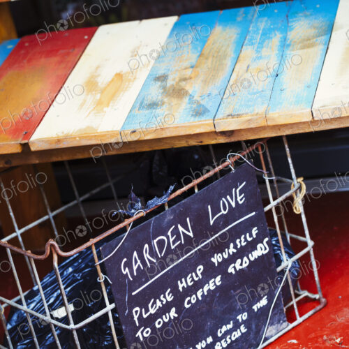 Specialist coffee shop. A wooden shelf and a container with a sign suggesting clients… Specialist coffee shop. A wooden shelf and a container with a sign suggesting clients…