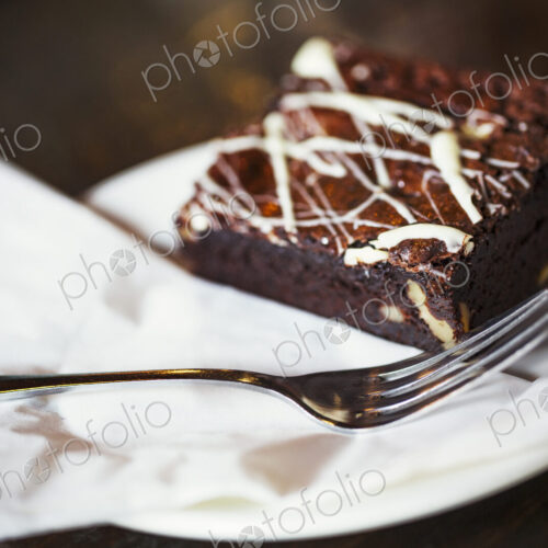 Specialist coffee shop. An iced chocolate brownie on a plate. Specialist coffee shop. An iced chocolate brownie on a plate.