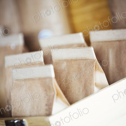 Specialist coffee shop. Bags of fresh ground coffee in a box on the counter. Specialist coffee shop. Bags of fresh ground coffee in a box on the counter.