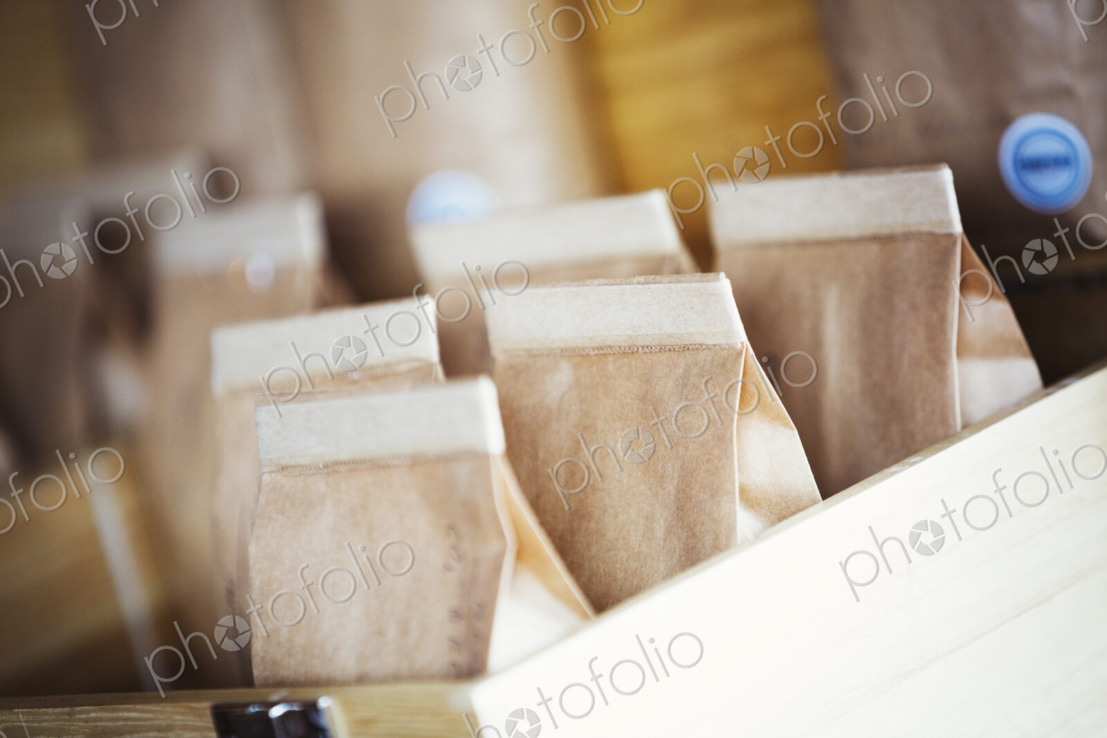 Specialist coffee shop. Bags of fresh ground coffee in a box on the counter.