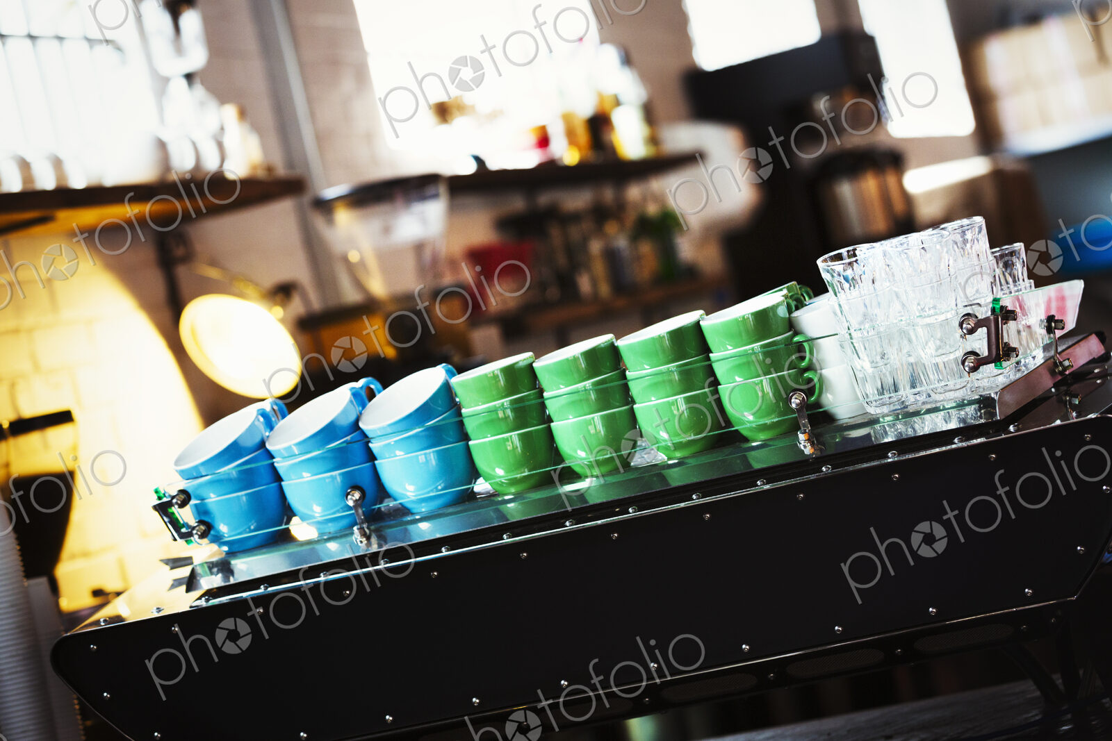 Specialist coffee shop. Blue and green coffee cups stacked up on the counter.