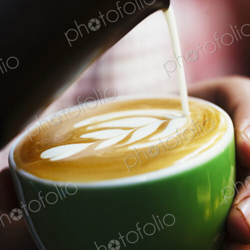 Specialist coffee shop. Cup of coffee with pattern in the froth on the top.
