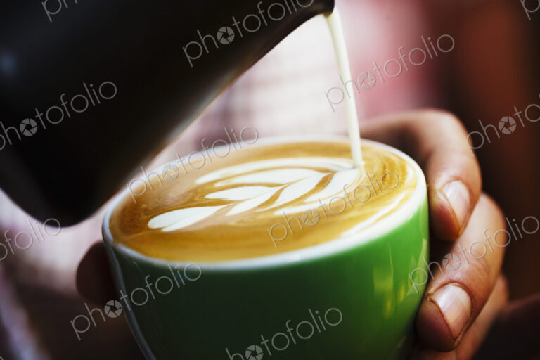 Specialist coffee shop. Cup of coffee with pattern in the froth on the top.